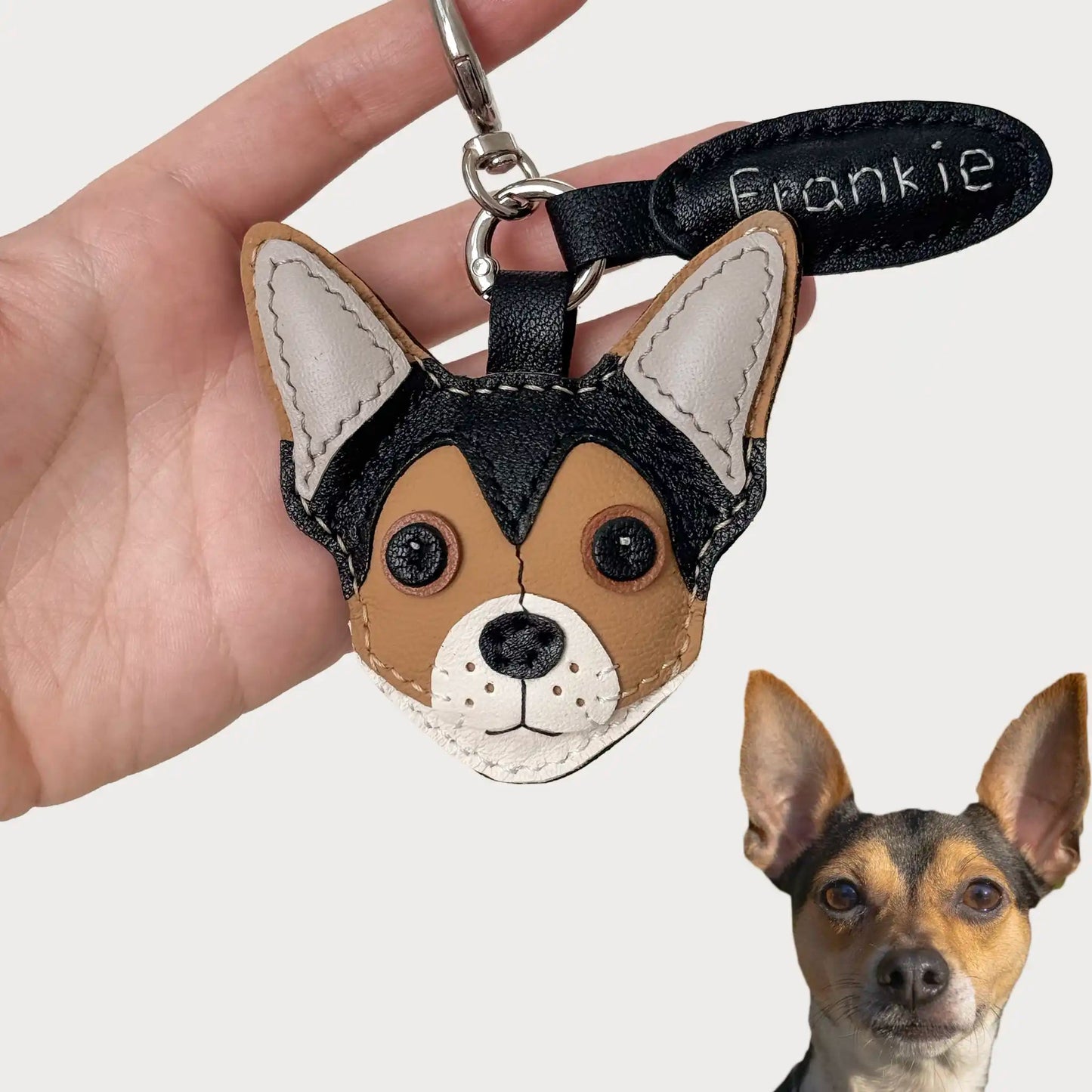 Handmade leather dog keychain charm of Frankie, with stitched details and name tag.