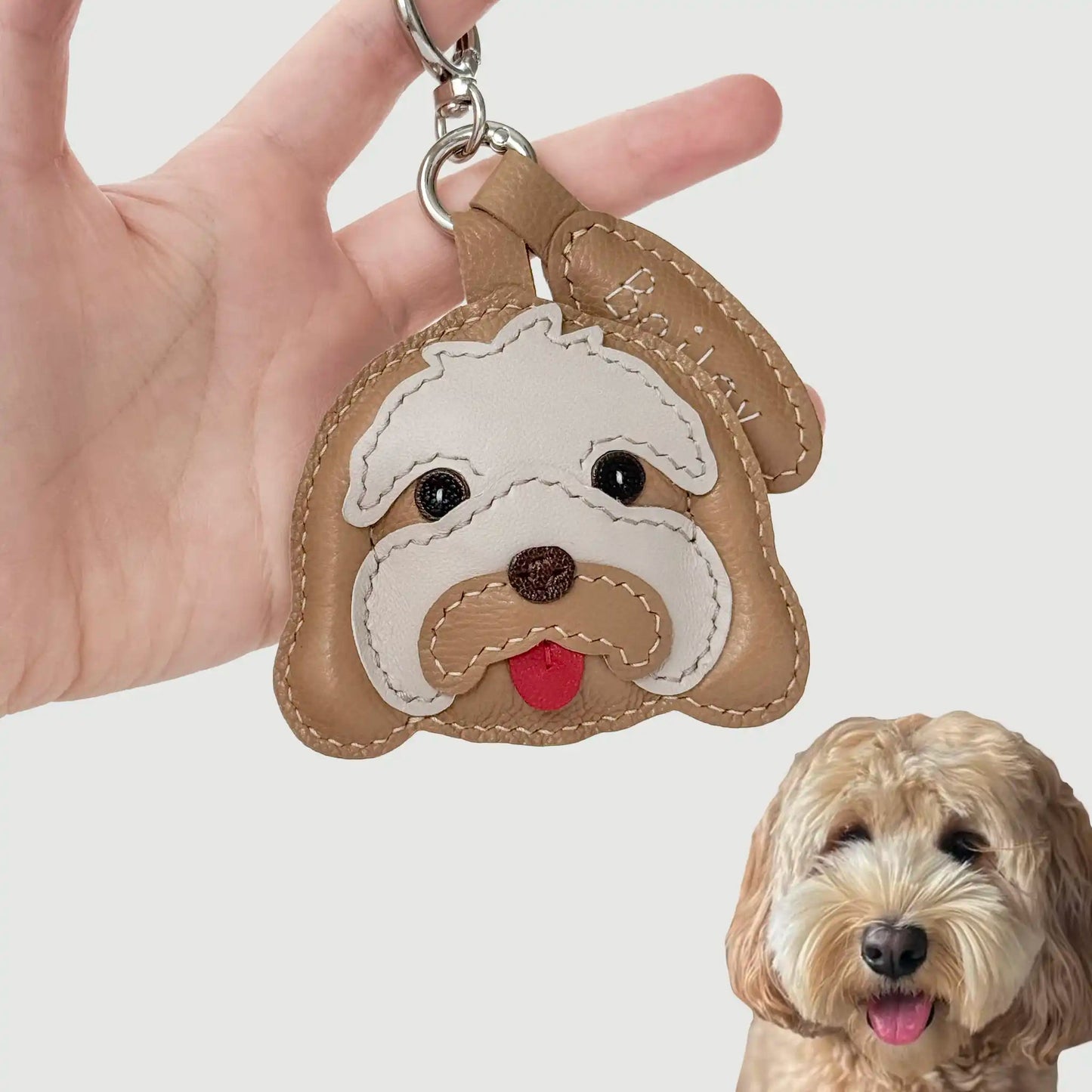 Custom-made handcrafted leather charm of Bailey, an Australian Labradoodle, with layered textures and a playful tongue.