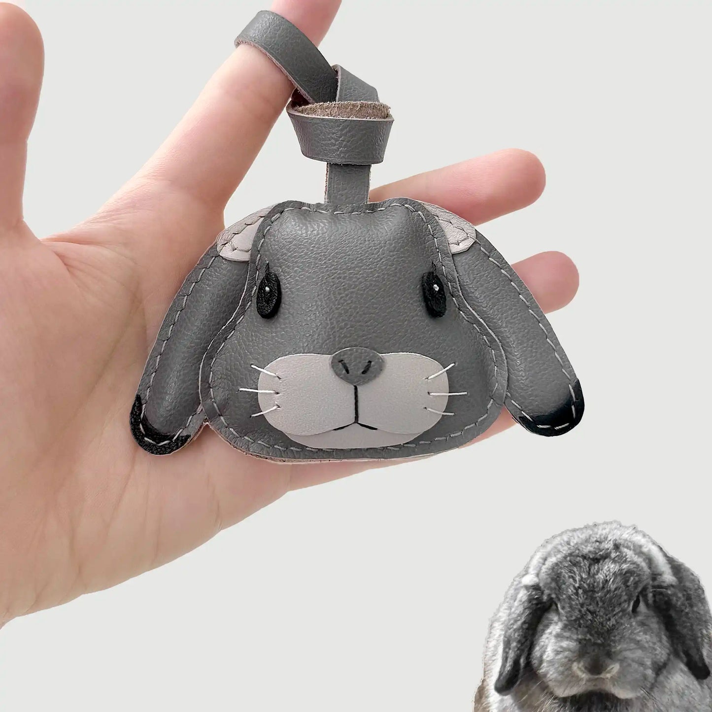 Handcrafted leather charm of Dundun, a lop-eared rabbit, custom-made in soft gray tones with long ears and a gentle look.