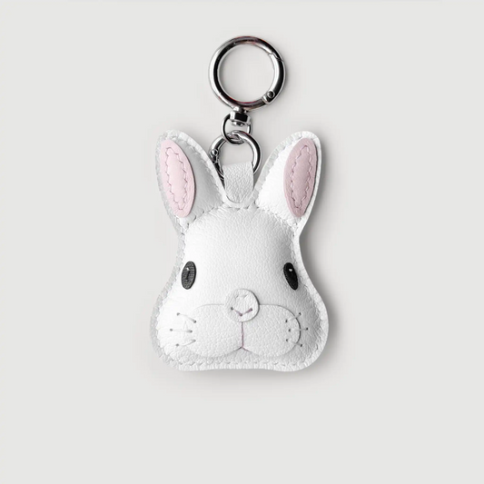 White rabbit-shaped keychain with pink accents on a light gray background