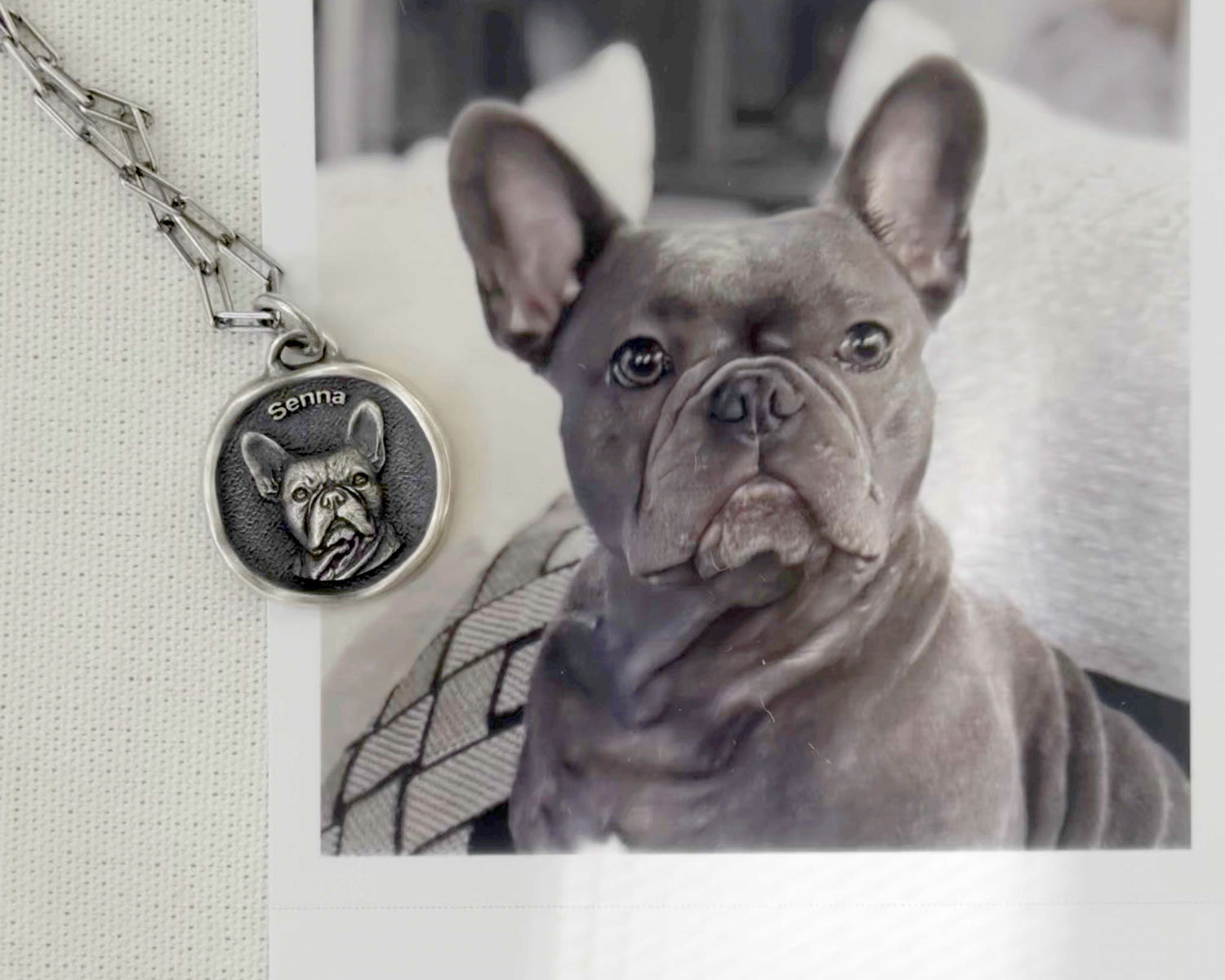 A 3D pendant with a dog’s face, shown next to her photo.
