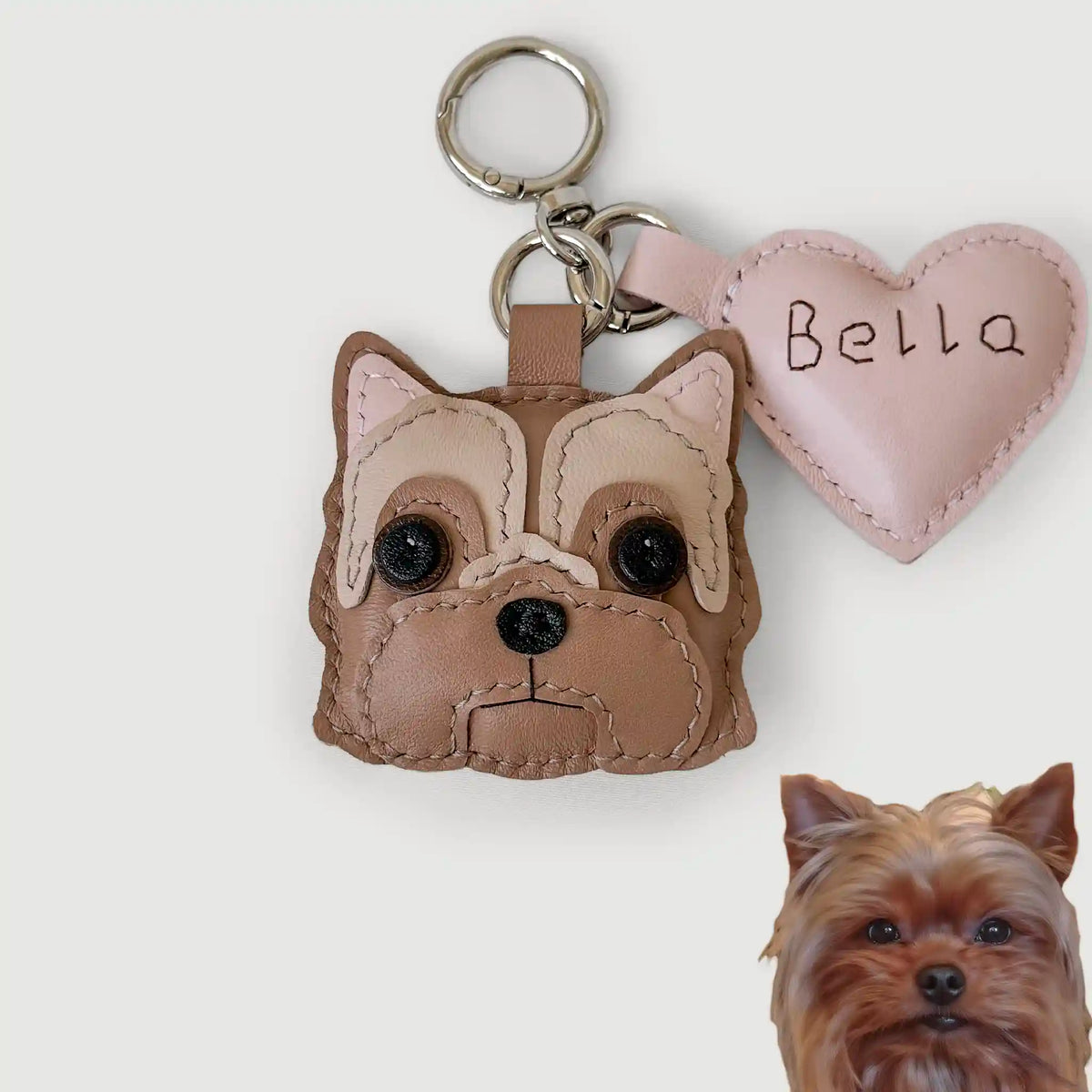 Dog-shaped keychain with a heart-shaped tag and a small dog photo on a white background