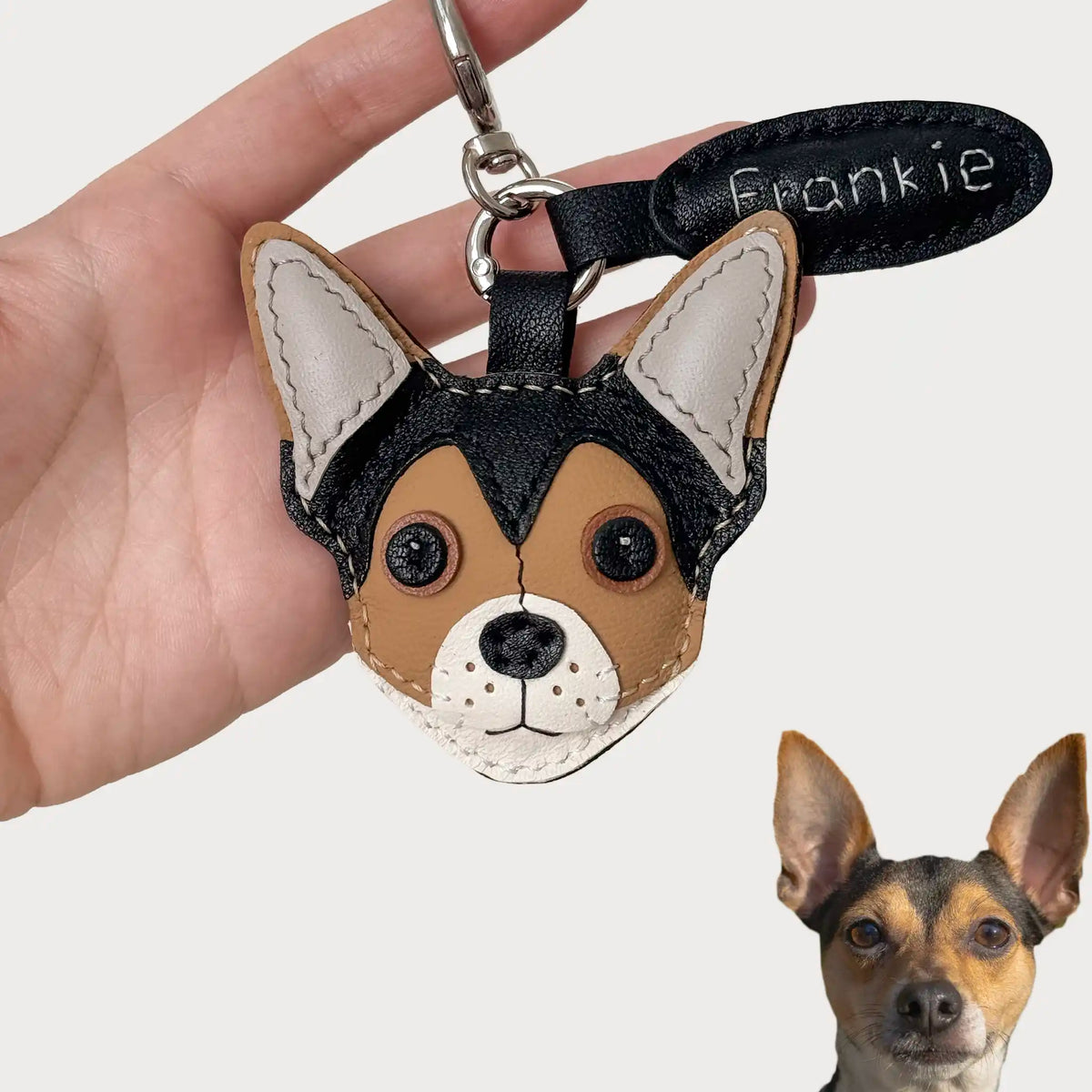 Handmade leather dog keychain charm of Frankie, with stitched details and name tag.