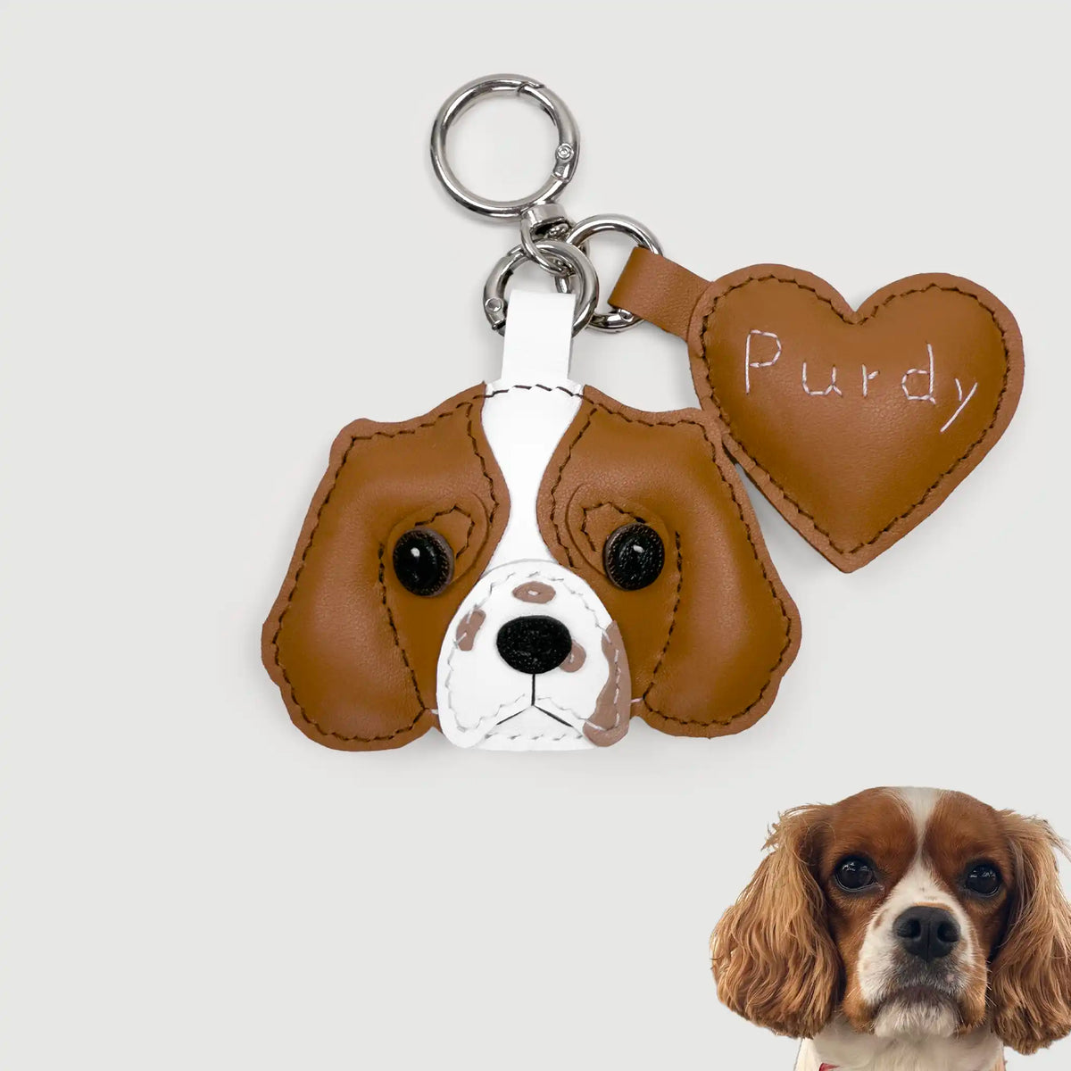 Dog-shaped keychain with heart-shaped tag and a dog's face on a white background