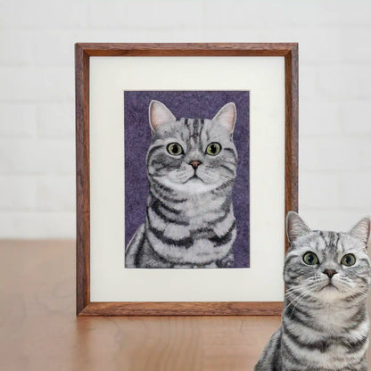 Wool felt portrait of Lianlian the silver American Shorthair, with green eyes and stripes, framed on a purple background.