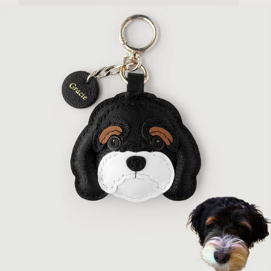 Dog-shaped keychain with a small dog next to it on a white background