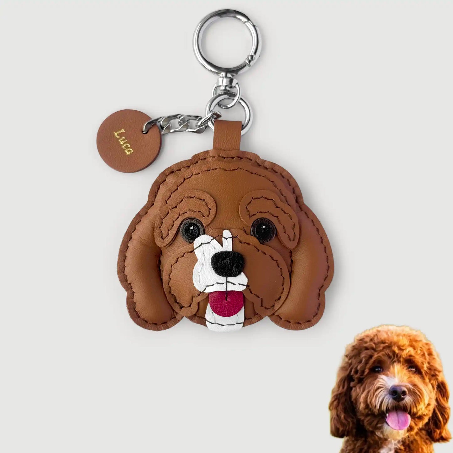 Brown dog-shaped keychain with a small dog in the corner on a light gray background