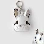 White rabbit-shaped keychain with brown accents on a light gray background