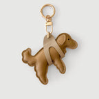Brown dog-shaped keychain on a light gray background