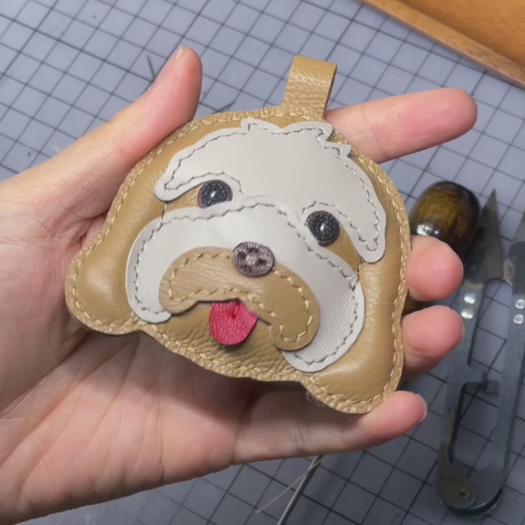 Video of crafting a custom leather keychain charm of an Australian Labradoodle, handmade pet keepsake.